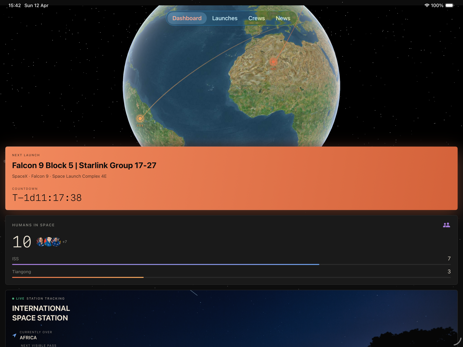 Astro Tracker dashboard showing Earth view, launch details, and humans in space.